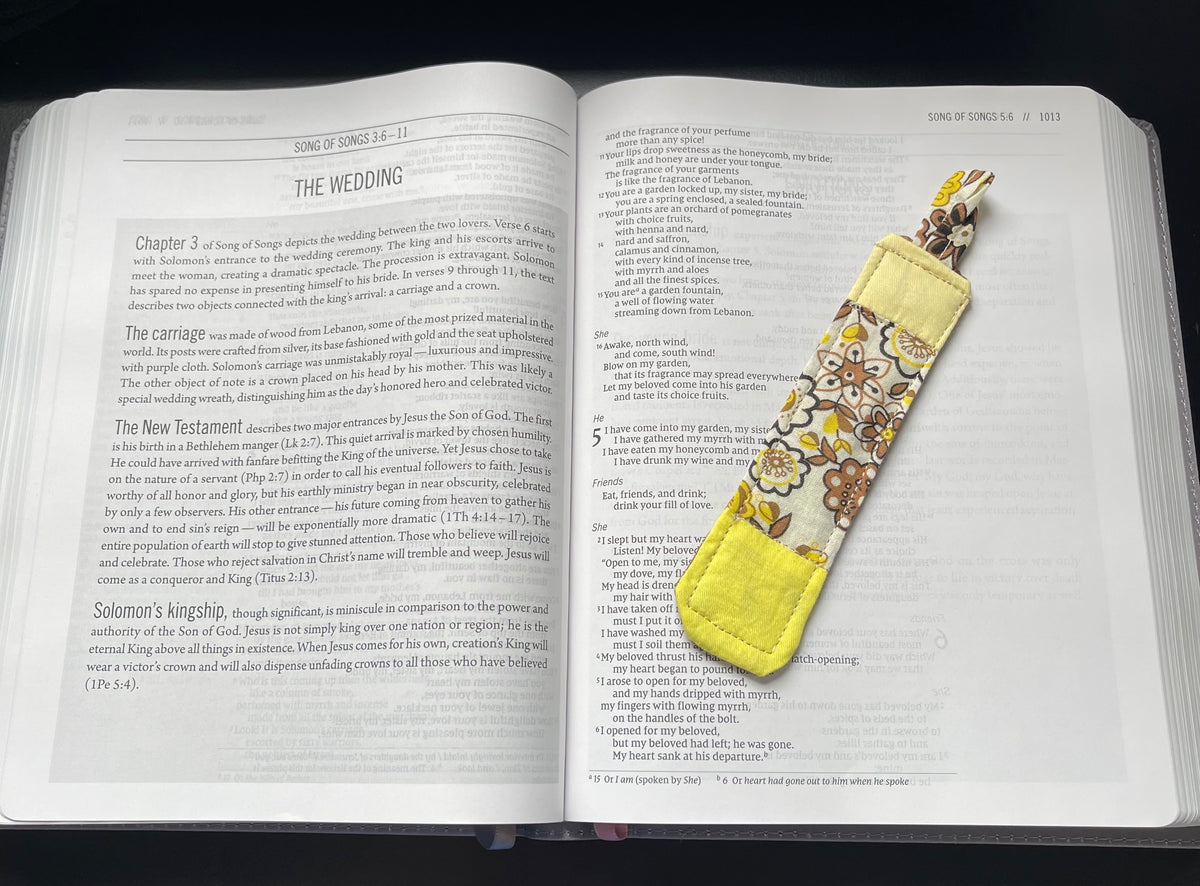 Golden Sunday quilted bookmark resting in an open Bible