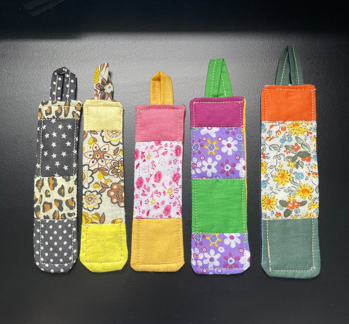 Front view of five handmade quilted bookmarks