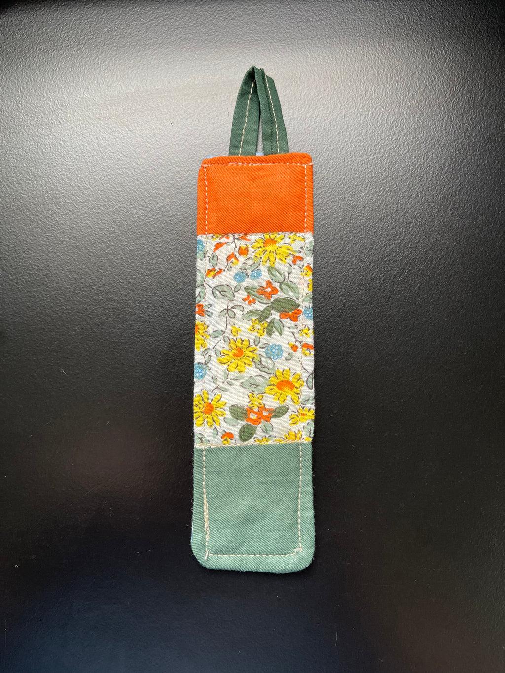 Garden Blessing handmade quilted bookmark with orange and green floral cotton fabric and light blue backing