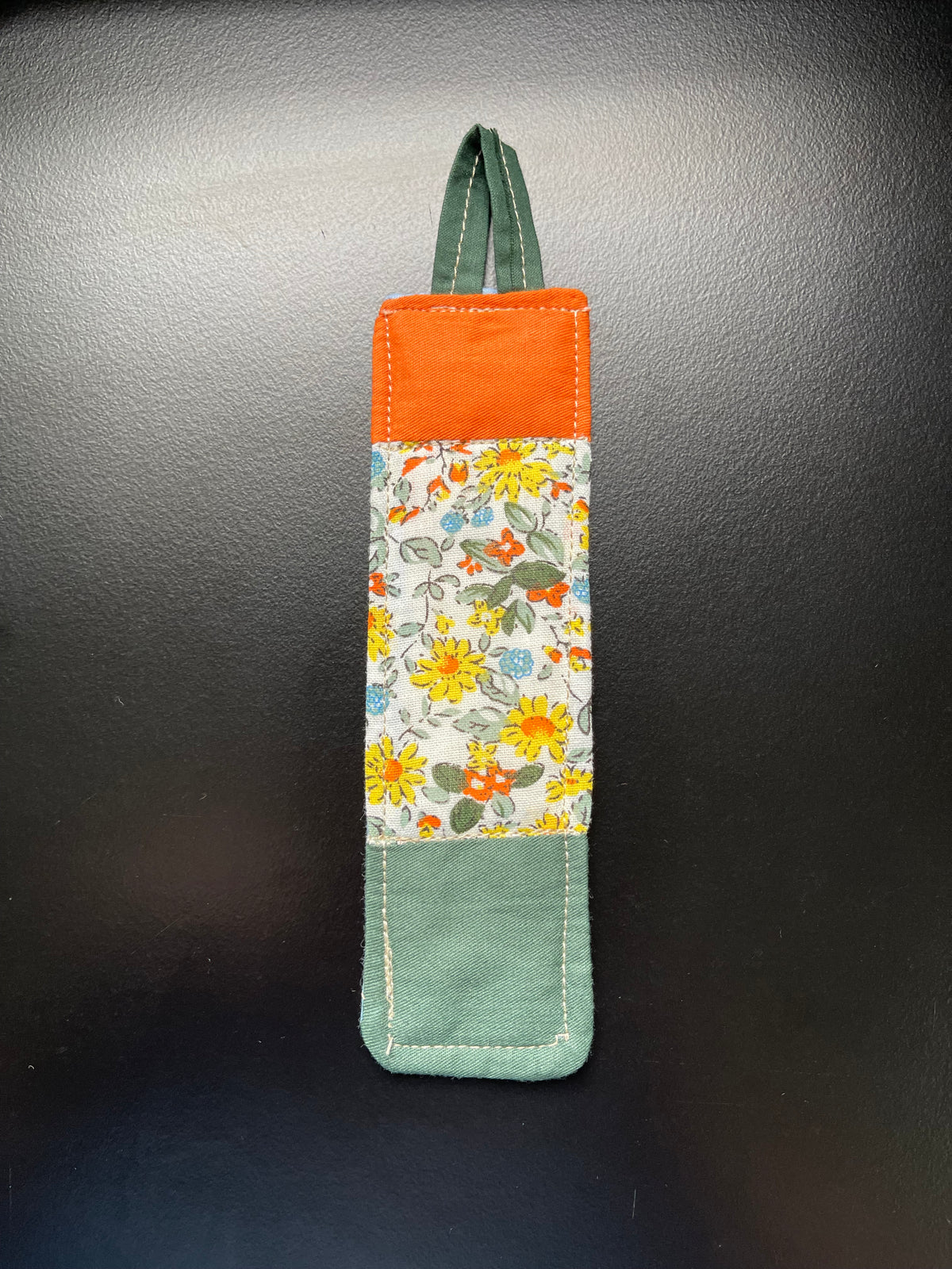 Garden Blessing handmade quilted bookmark with orange and green floral cotton fabric and light blue backing
